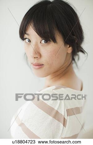 Portrait of young woman, studio shot View Large Photo Image Stock Image - Portrait of young woman, studio shot. Fotosearch