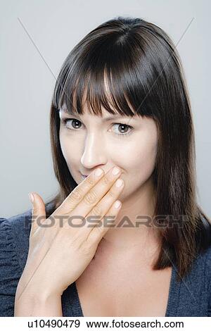 Stock Photo - Portrait of young woman, studio shot. Fotosearch