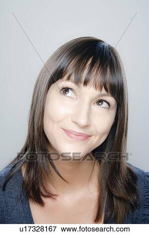 Stock Photo - Portrait of young woman, studio shot. Fotosearch