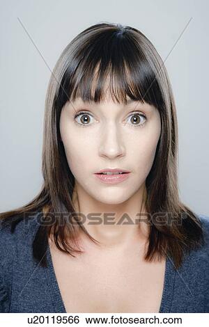 Stock Photograph - Portrait of young woman, studio shot. Fotosearch