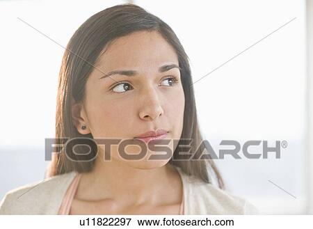 Stock Photo - Portrait of young woman thinking. Fotosearch