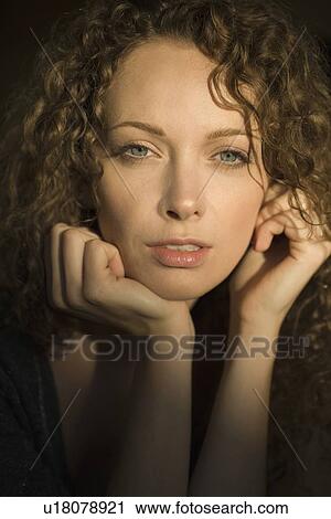 Portrait of young woman with curly hair View Large Photo Image Stock Image - Portrait of young woman with curly hair. Fotosearch