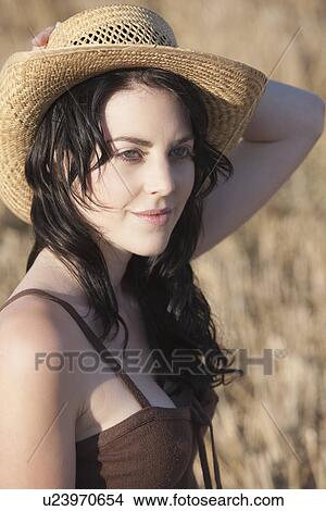 Picture - Portrait of young woman with straw hat. Fotosearch