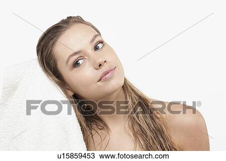 Stock Image - Portrait of young woman with wet hair and towel. Fotosearch