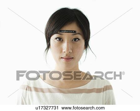 Portrait of young woman with word 'American' on forehead, studio shot View Large Photo Image Stock Image - Portrait of young woman with word 'American' on forehead, studio shot. Fotosearch