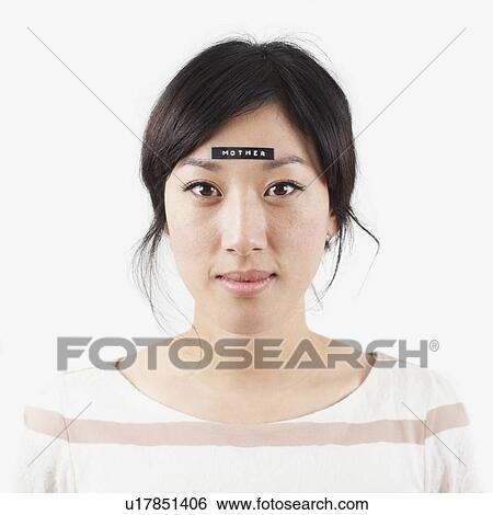 Portrait of young woman with word 'mother' on forehead, studio shot View Large Photo Image Stock Photograph - Portrait of young woman with word 'mother' on forehead, studio shot. Fotosearch
