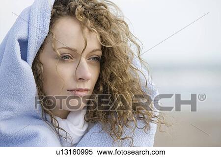 Portrait of young woman wrapped in blanket View Large Photo Image Stock Photography - Portrait of young woman wrapped in blanket. Fotosearch