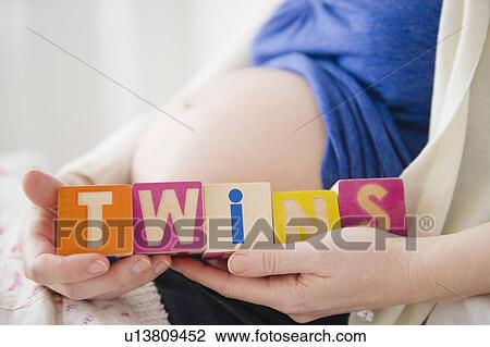 Pregnant woman holding wooden blocks View Large Photo Image Stock Image - Pregnant woman holding wooden blocks . Fotosearch