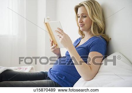 Pregnant woman reading book in bed View Large Photo Image Stock Photo - Pregnant woman reading book in bed. Fotosearch