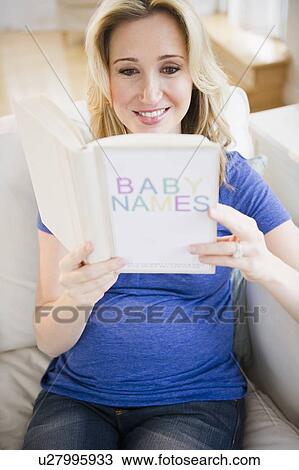 Stock Image - Pregnant woman reading book. Fotosearch