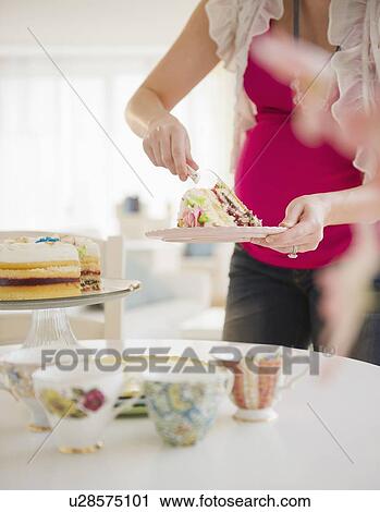 Pregnant woman serving cake View Large Photo Image Stock Image - Pregnant woman serving cake. Fotosearch
