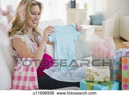 Pregnant woman unpacking gifts View Large Photo Image Stock Photograph - Pregnant woman unpacking gifts. Fotosearch