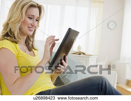 Pregnant woman using digital tablet View Large Photo Image Stock Image - Pregnant woman using digital tablet. Fotosearch