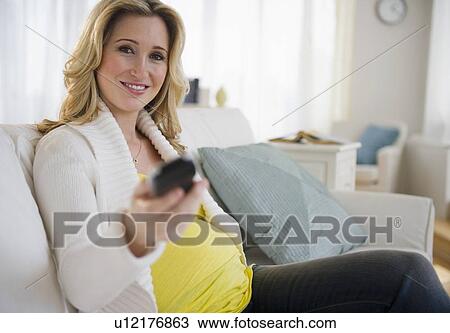 Pregnant woman watching tv View Large Photo Image Stock Image - Pregnant woman watching tv. Fotosearch