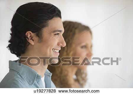 Stock Photo - Profile of couple with focus on man in foreground. Fotosearch