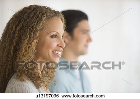 Profile of couple with focus on woman in foreground View Large Photo Image Stock Photograph - Profile of couple with focus on woman in foreground. Fotosearch