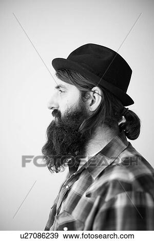 Profile of male character wearing long beard, hat and lumberjack shirt View Large Photo Image Stock Photo - Profile of male character wearing long beard, hat and lumberjack shirt. Fotosearch