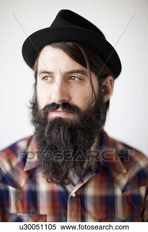 Stock Photography - Profile of male character wearing long beard, hat and lumberjack shirt. Fotosearch