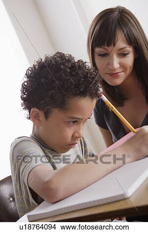 Pupil writing together with teacher View Large Photo Image Picture - Pupil writing together with teacher. Fotosearch