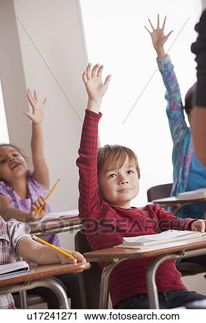 Pupils in classroom raising hands View Large Photo Image Stock Image - Pupils in classroom raising hands. Fotosearch