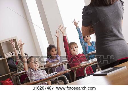 Pupils in classroom raising hands View Large Photo Image Stock Photo - Pupils in classroom raising hands. Fotosearch