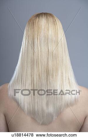 Stock Photo - Rear view of woman with blonde hair, studio shot. Fotosearch