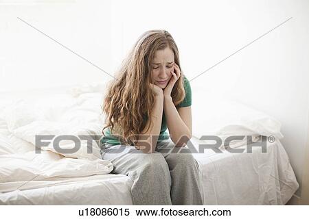 Sad young woman sitting in bed View Large Photo Image Stock Photography - Sad young woman sitting in bed. Fotosearch