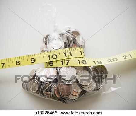 Savings in plastic bag tied up with tape measure View Large Photo Image Stock Photograph - Savings in plastic bag tied up with tape measure. Fotosearch