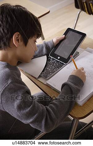Schoolboy (12-13) with digital tablet at school View Large Photo Image Picture - Schoolboy (12-13) with digital tablet at school. Fotosearch