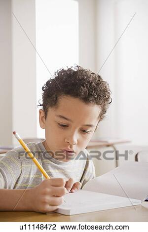 Schoolboy writing in notebook View Large Photo Image Stock Image - Schoolboy writing in notebook. Fotosearch