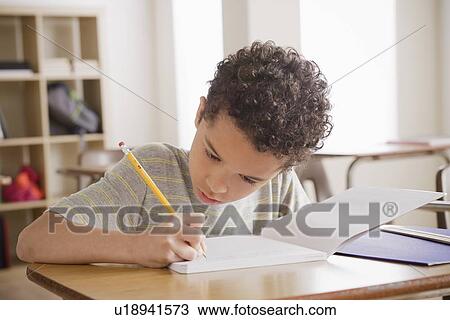 Schoolboy writing in notebook View Large Photo Image Stock Image - Schoolboy writing in notebook. Fotosearch