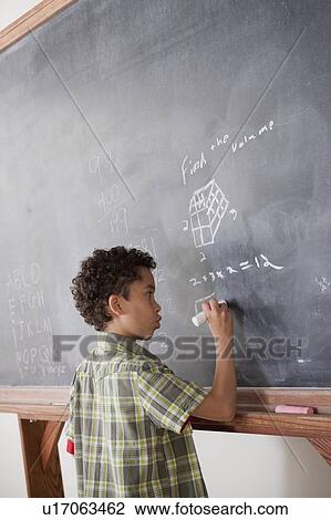 Schoolboy writing on blackboard View Large Photo Image Stock Image - Schoolboy writing on blackboard. Fotosearch