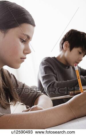 Stock Image - Schoolchildren (12-13) at school. Fotosearch