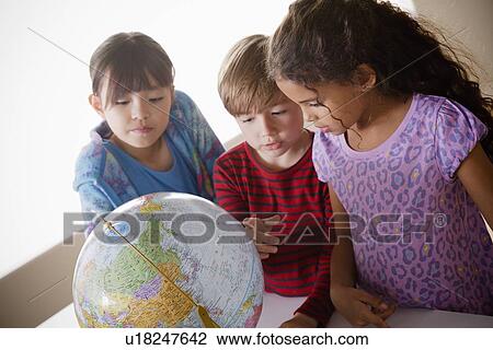 Schoolchildren (6-7, 8-9) with globe View Large Photo Image Stock Image - Schoolchildren (6-7, 8-9) with globe. Fotosearch
