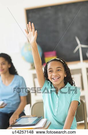 Schoolgirl (10-13) raising hand View Large Photo Image Stock Photo - Schoolgirl (10-13) raising hand. Fotosearch