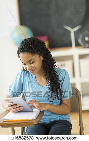 Schoolgirl (12-13) using tablet pc View Large Photo Image Stock Photo - Schoolgirl (12-13) using tablet pc. Fotosearch