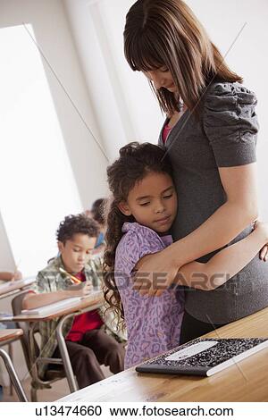 Schoolgirl (6-7) embracing teacher View Large Photo Image Stock Image - Schoolgirl (6-7) embracing teacher. Fotosearch