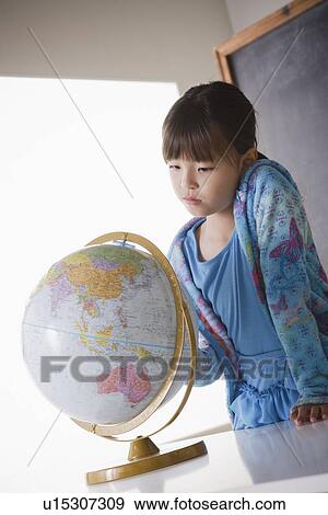 Schoolgirl (8-9) with globe View Large Photo Image Stock Photo - Schoolgirl (8-9) with globe. Fotosearch
