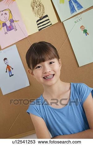 Schoolgirl in classroom View Large Photo Image Stock Image - Schoolgirl in classroom. Fotosearch
