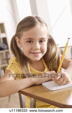 Schoolgirl writing in notebook View Large Photo Image Stock Image - Schoolgirl writing in notebook. Fotosearch