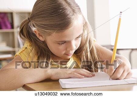 Schoolgirl writing in notebook View Large Photo Image Stock Image - Schoolgirl writing in notebook. Fotosearch