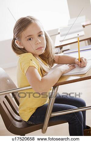 Schoolgirl writing in notebook View Large Photo Image Stock Photo - Schoolgirl writing in notebook. Fotosearch