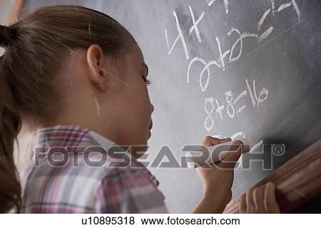 Schoolgirl writing on blackboard View Large Photo Image Stock Photo - Schoolgirl writing on blackboard. Fotosearch