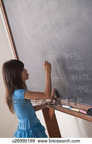 Schoolgirl writing on blackboard View Large Photo Image Stock Photo - Schoolgirl writing on blackboard. Fotosearch