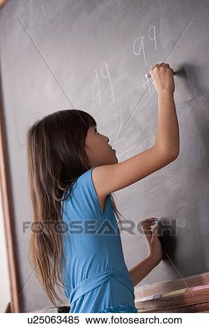 Schoolgirl writing on blackboard View Large Photo Image Stock Photography - Schoolgirl writing on blackboard. Fotosearch