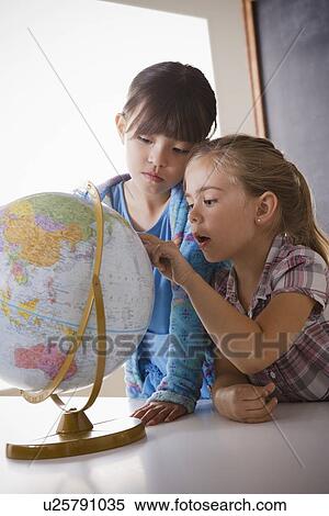 Schoolgirls (6-7, 8-9) with globe View Large Photo Image Stock Photography - Schoolgirls (6-7, 8-9) with globe. Fotosearch
