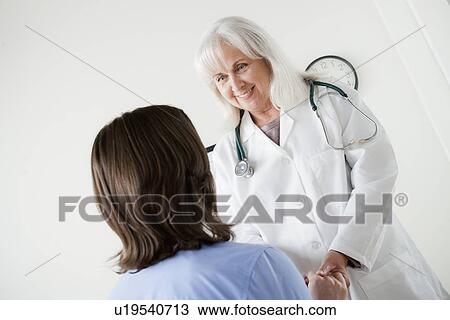 Senior doctor talking with patient View Large Photo Image Stock Image - Senior doctor talking with patient. Fotosearch