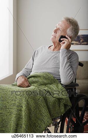 Senior man on wheelchair talking via mobile View Large Photo Image Stock Image - Senior man on wheelchair talking via mobile. Fotosearch