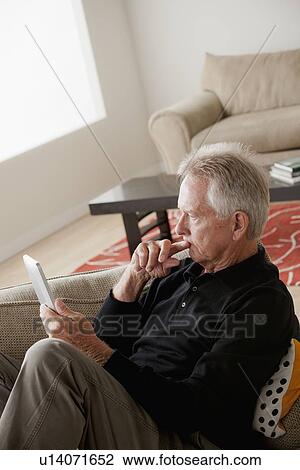 Stock Image - Senior man using digital tablet. Fotosearch