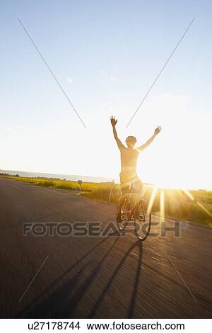 Silhouette of cyclist holding arms up View Large Photo Image Picture - Silhouette of cyclist holding arms up. Fotosearch